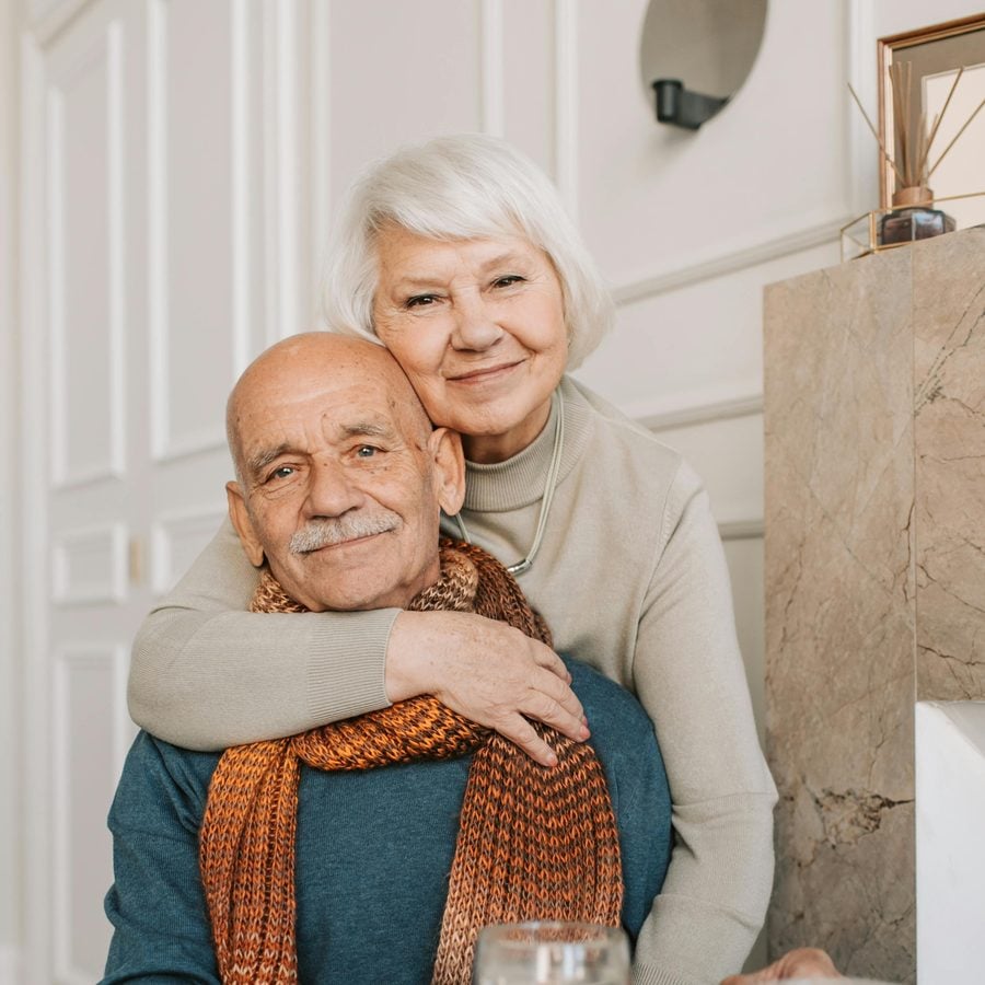 Smiling senior couple at home — Maher Insurance Group serves clients of every age